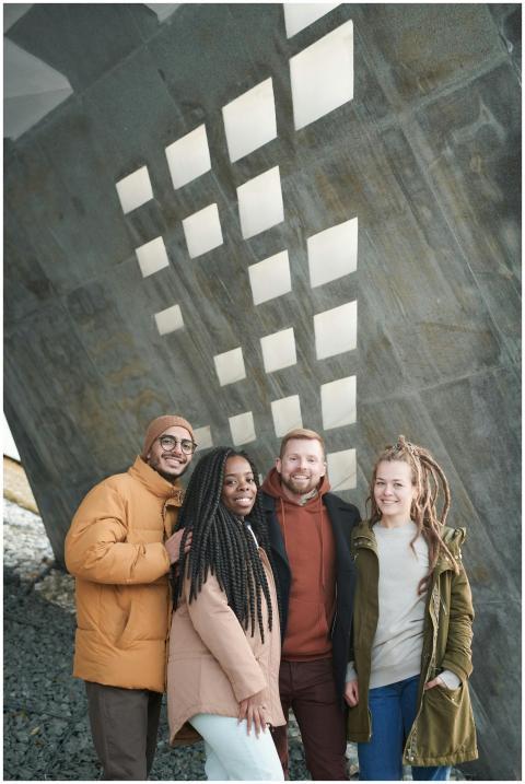 Four diverse friends smiling in an urban setting u