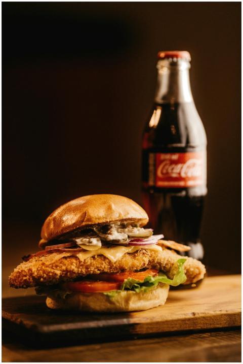Mouth-watering burger with a bottle of cola, perfe