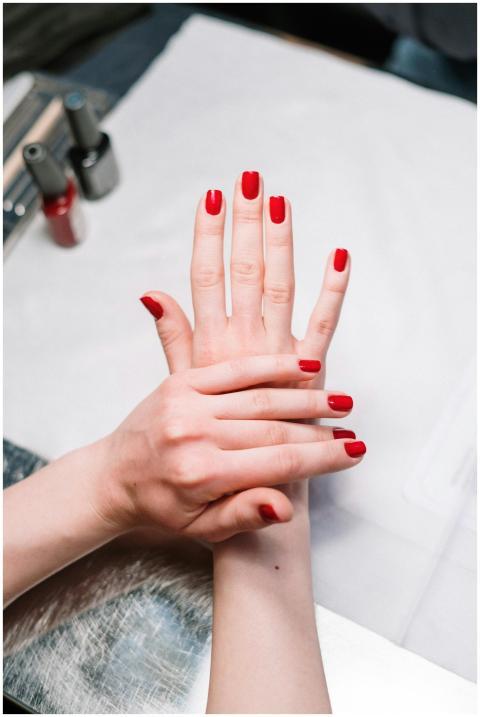 Close-up of elegant red nail polish on hands in a