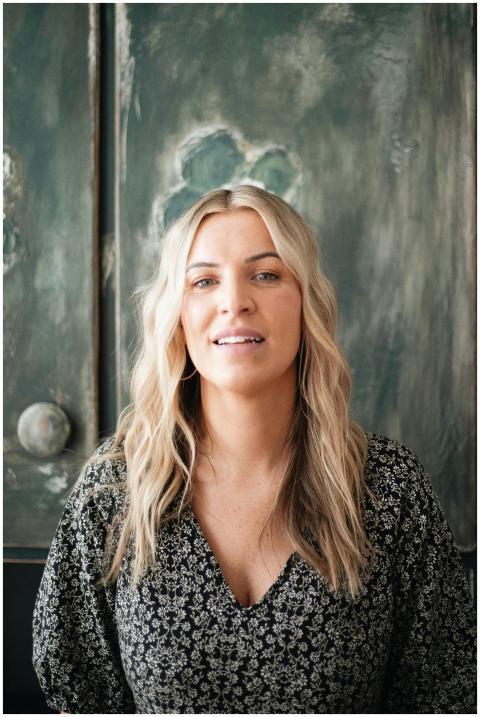 Authentic natural light headshot of a woman with b