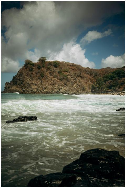 Waves crashing against rocky cliffs on a scenic be