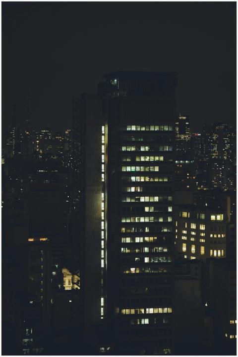 A nighttime cityscape featuring illuminated skyscr
