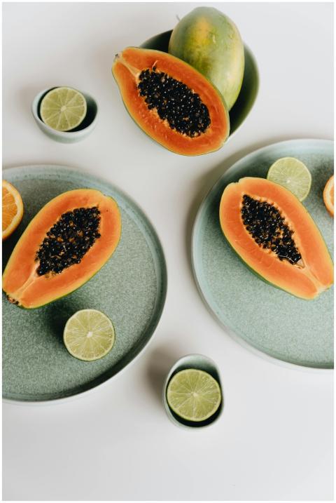 Vibrant image of sliced papaya and lime on pastel