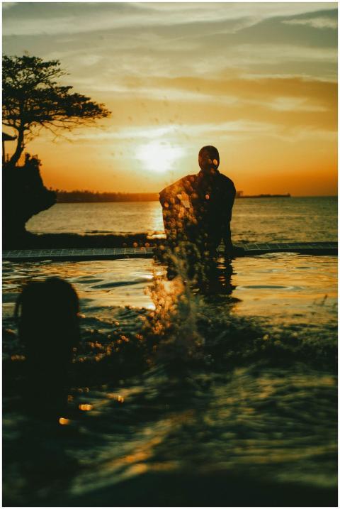 Artistic silhouette of people enjoying a poolside