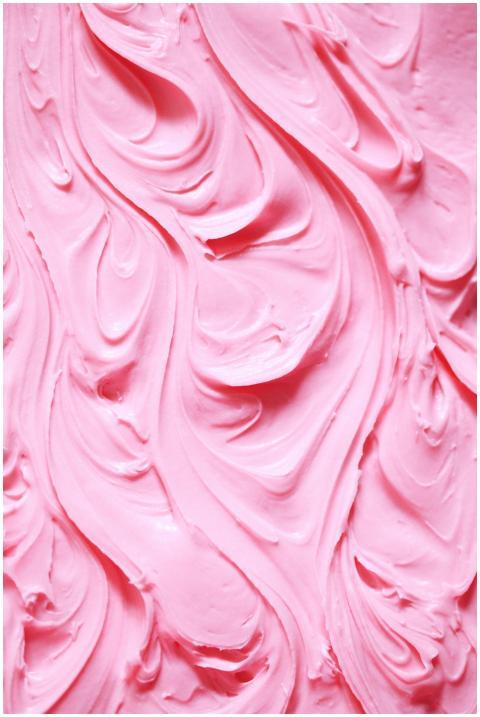 Detailed swirls of creamy pink frosting creating a