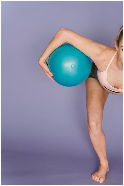 Crop anonymous barefoot female in activewear pract