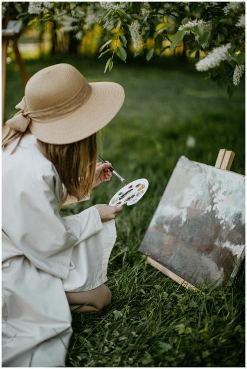 Young woman painting in a lush garden, capturing n