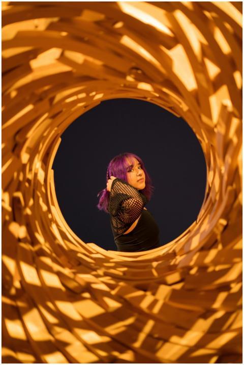 Woman with vibrant purple hair framed artistically