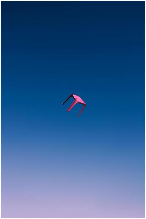 Unique perspective of a pink chair floating in a c