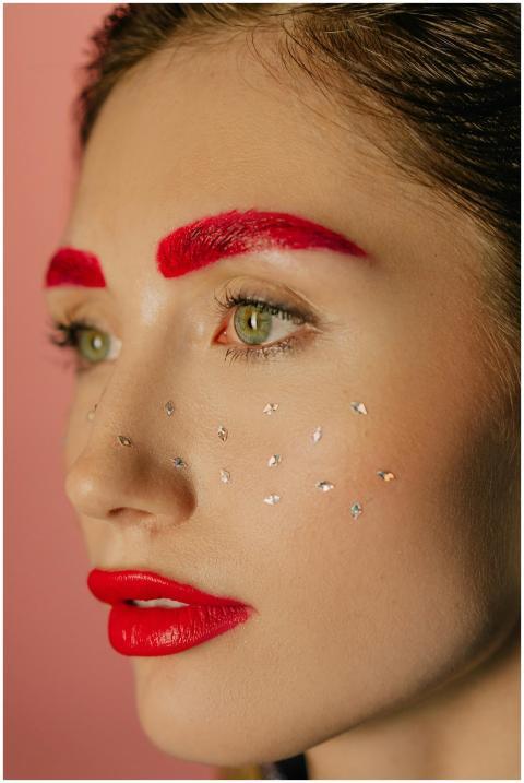 Close-up portrait of a woman with bold red makeup