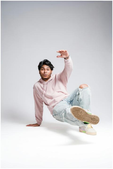 Energetic dance pose captured in a modern studio.