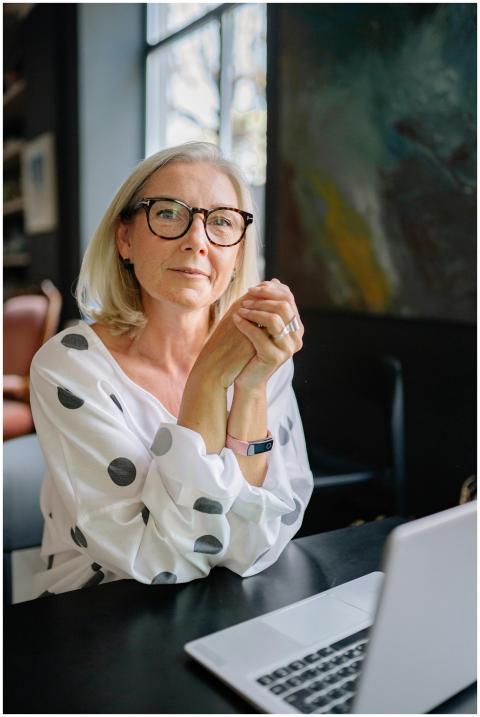 Senior woman with eyeglasses and polka dot blouse