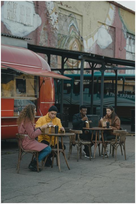 Group of diverse friends enjoying a meal outside a