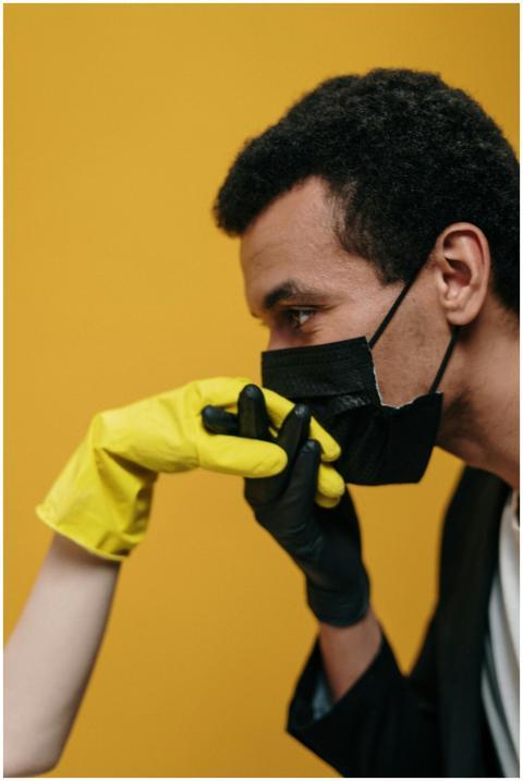 A couple engages in a romantic gesture while weari