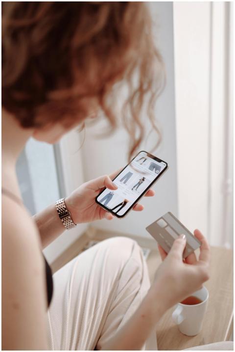 A woman using a smartphone for online shopping, ho