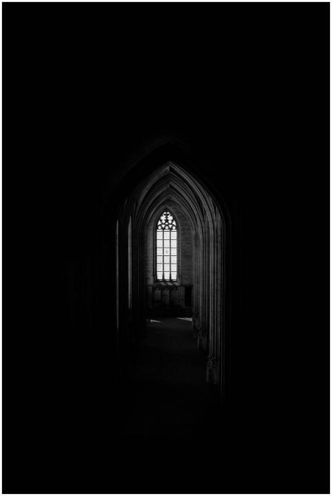 A captivating gothic archway leading to a faintly