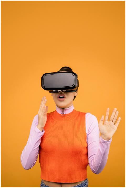 Woman immersed in virtual reality, wearing a VR he