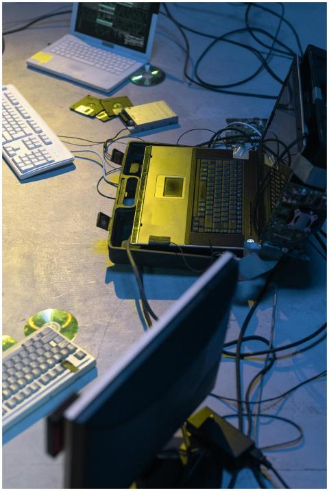 Cyberpunk-themed setup with laptops, keyboards, wi