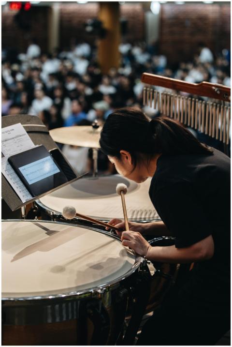A percussionist playing timpani during a live orch