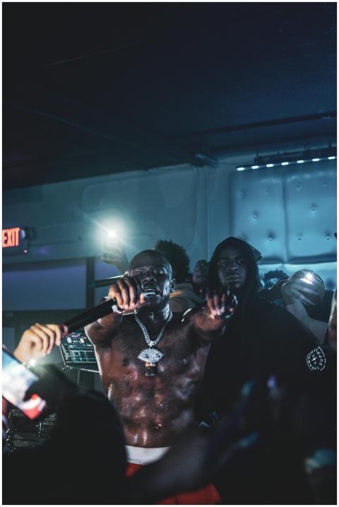 A dynamic rapper performs energetically on stage d