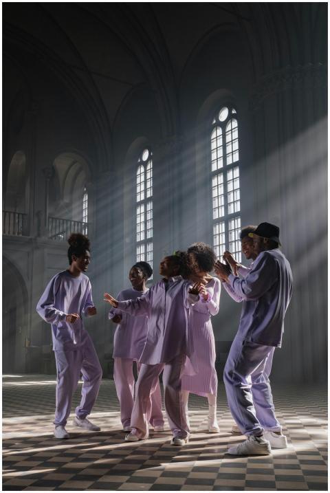 Group of singers performing in a sunlit cathedral