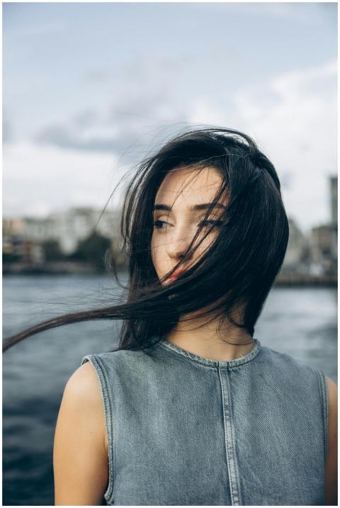 A young woman with flowing hair stands by the Bosp