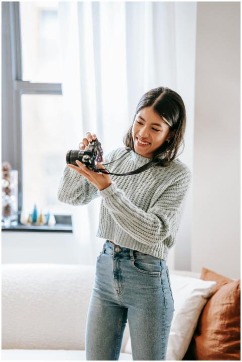 Positive young Latin American female photographer