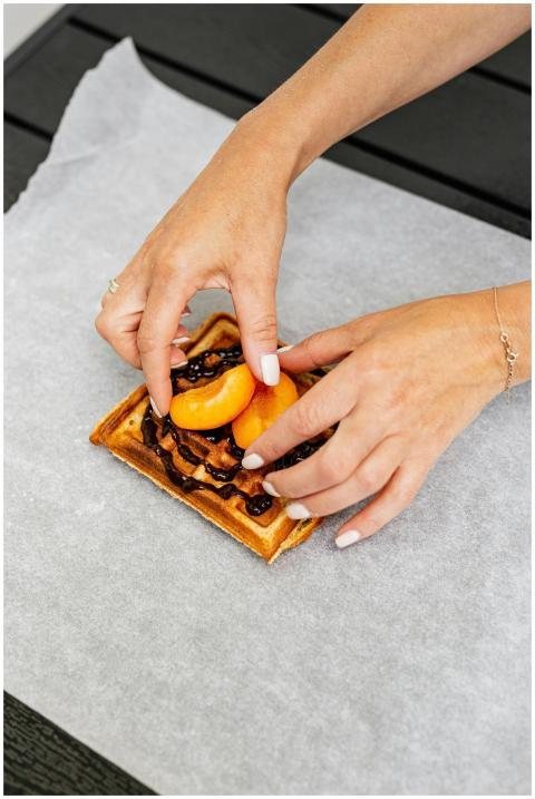 Delicious waffle topped with chocolate and fresh p