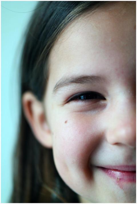 Delightful close-up of a young girl smiling, evoki