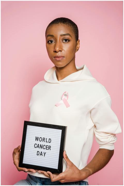 Young African American woman holding World Cancer