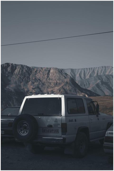 Parked off-road vehicles with rugged mountainous b