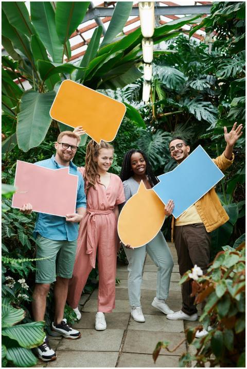 Cheerful group of friends holding colorful speech
