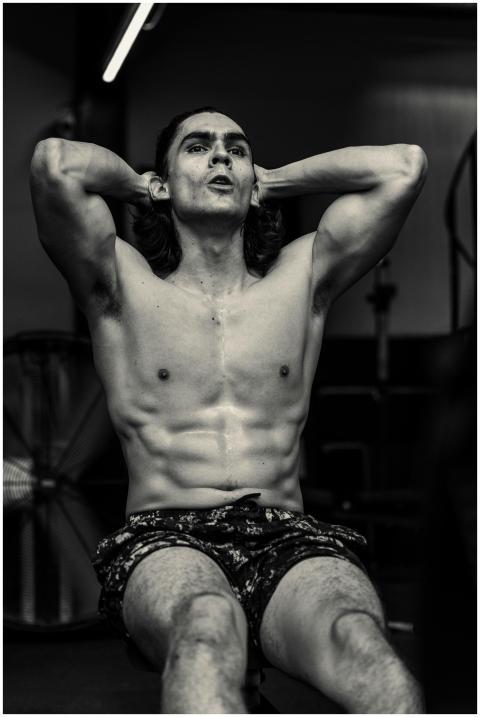 Black and white photo of a man doing abdominal exe