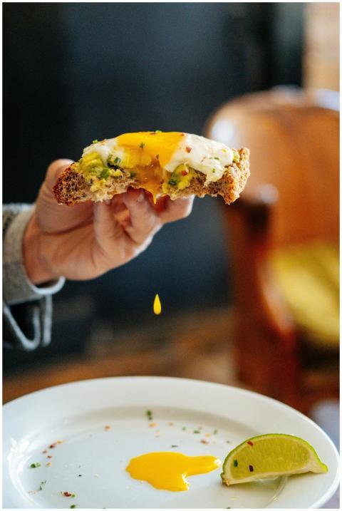 Delicious avocado toast topped with a poached egg,