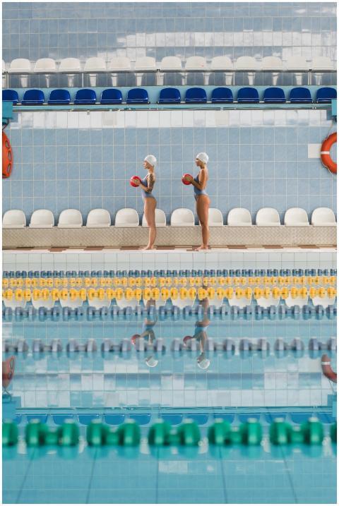 Two female swimmers practicing synchronized swimmi