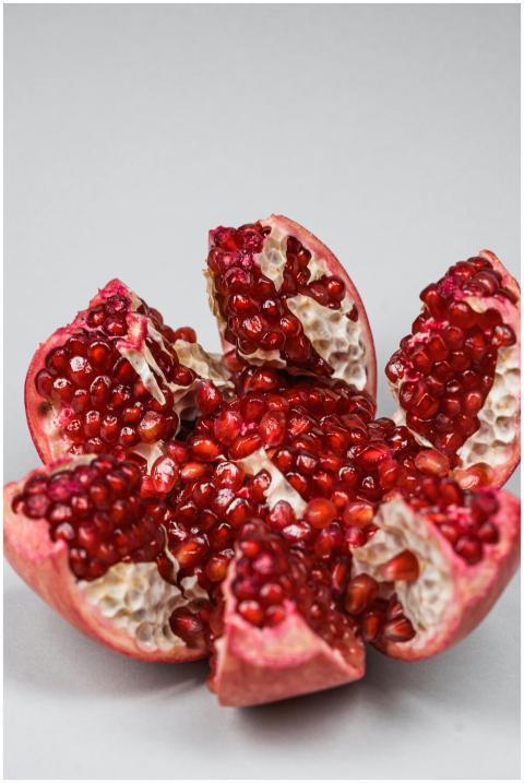 Detailed view of a sliced pomegranate displaying v