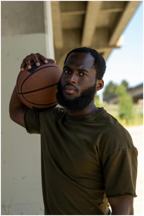 Athletic African American man with beard holding b