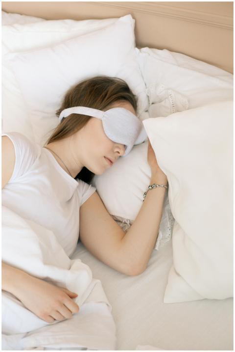 A serene scene of a woman sleeping with a white sl