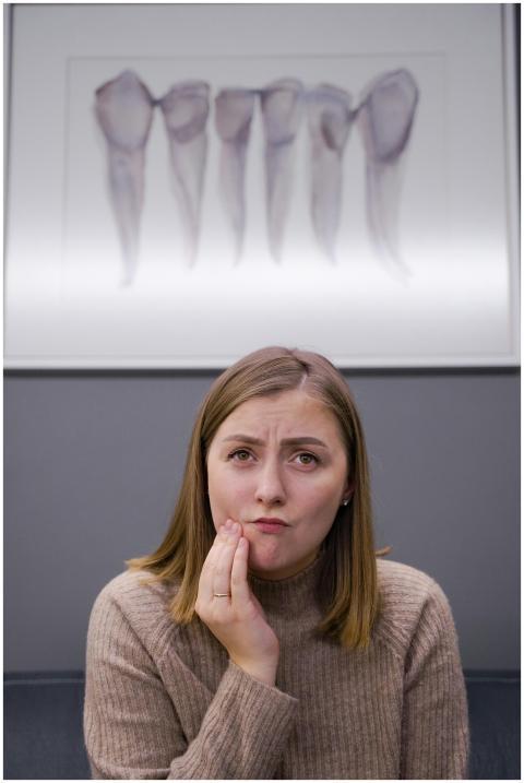 Caucasian woman feels toothache in modern dental c