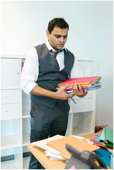 A focused businessman organizing folders in a mode