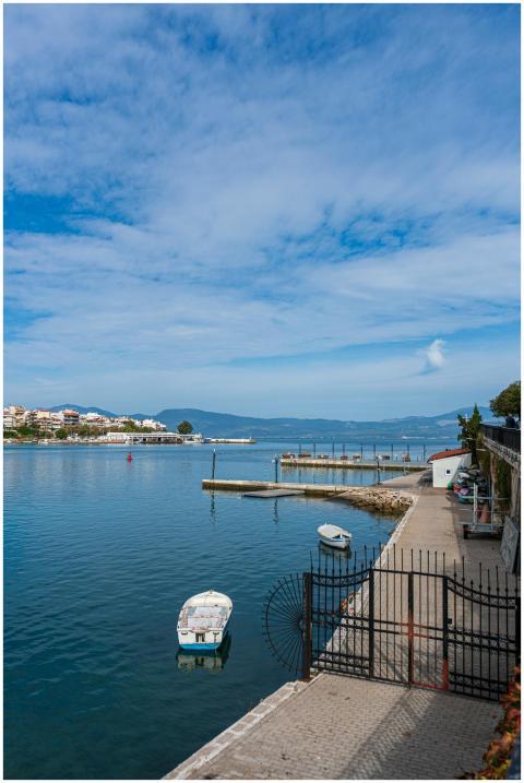 Explore a tranquil coastal landscape with boats, a