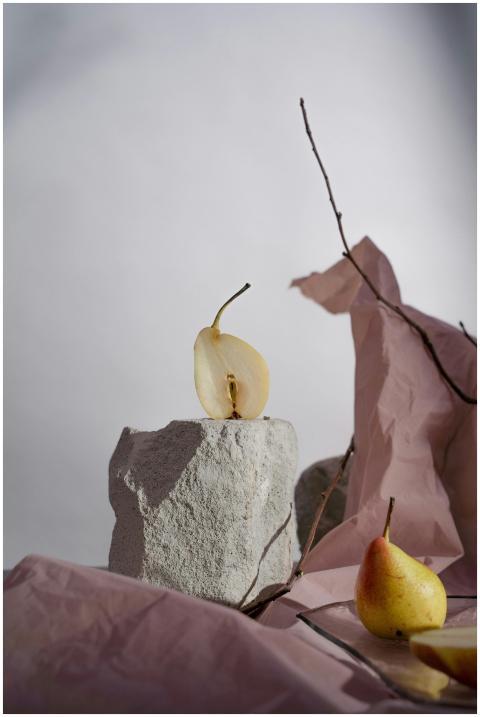 A minimalist still life composition featuring cut