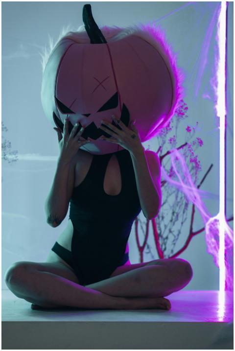 Person wearing a unique pumpkin costume in a vibra