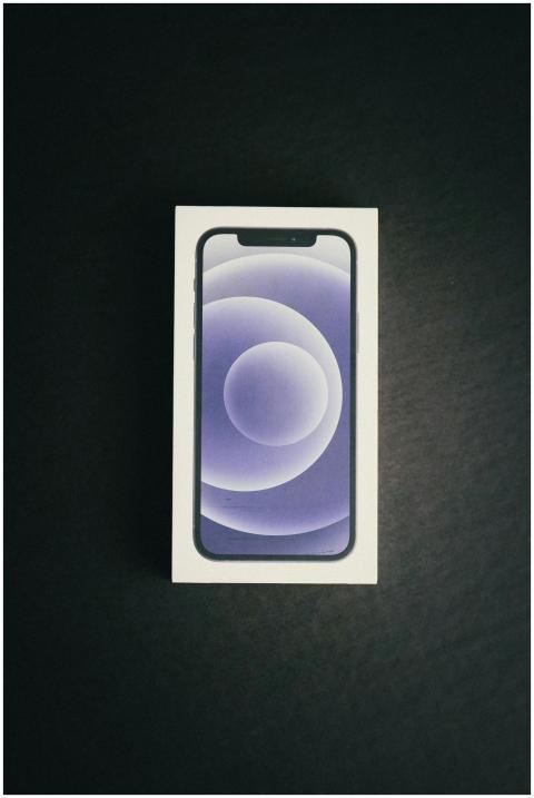 A new smartphone in its packaging on a black backg