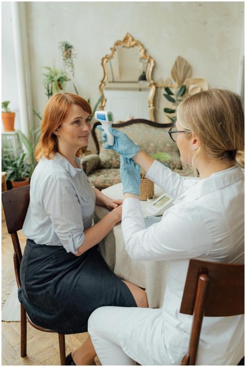 A doctor measuring a patient's temperature with a