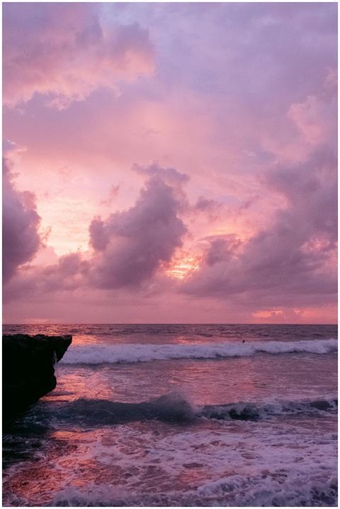 Breathtaking pink sunset over Bali's ocean with dr