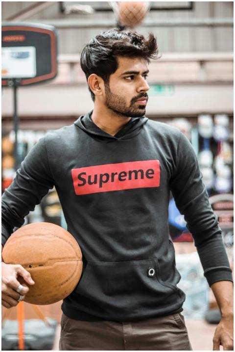 Portrait of a young man holding a basketball on an