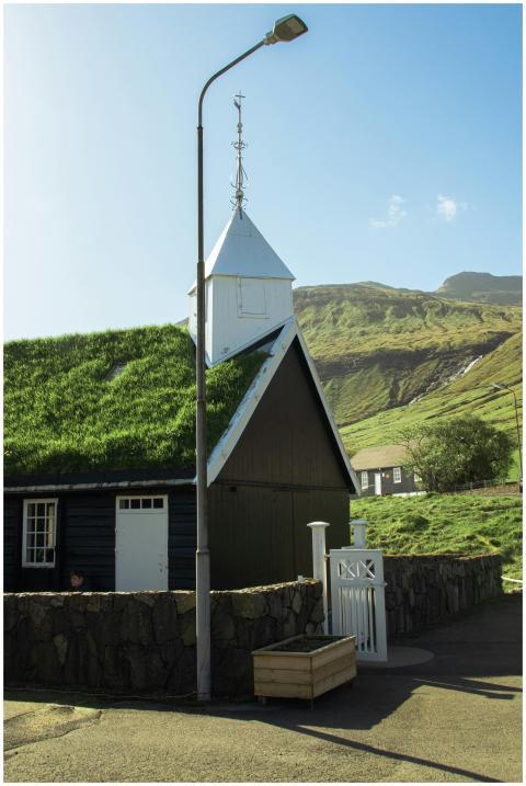 A traditional Faroese house with a grass roof set