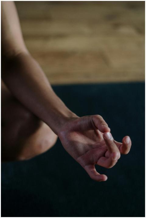 A close-up view of a hand in a yoga mudra position