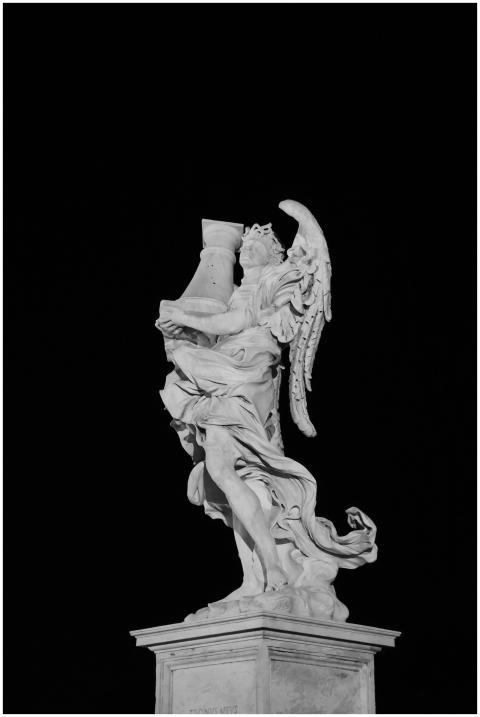 Monochrome photo of a majestic angel statue agains